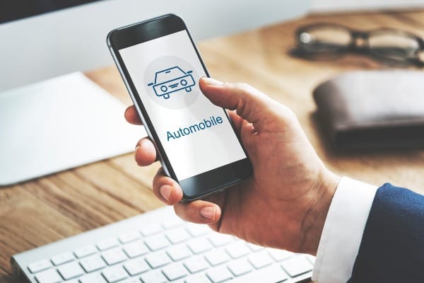 Person using a smartphone to browse auto insurance options online