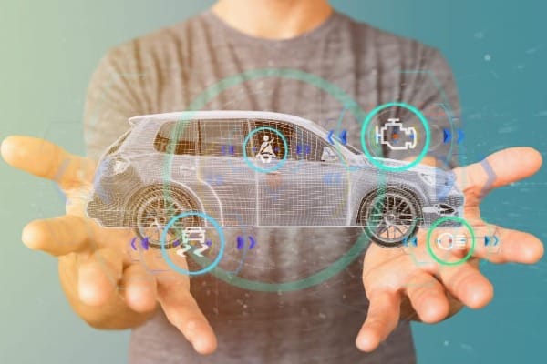 Digital car interface floating above hands, symbolizing data-driven technology in auto insurance.